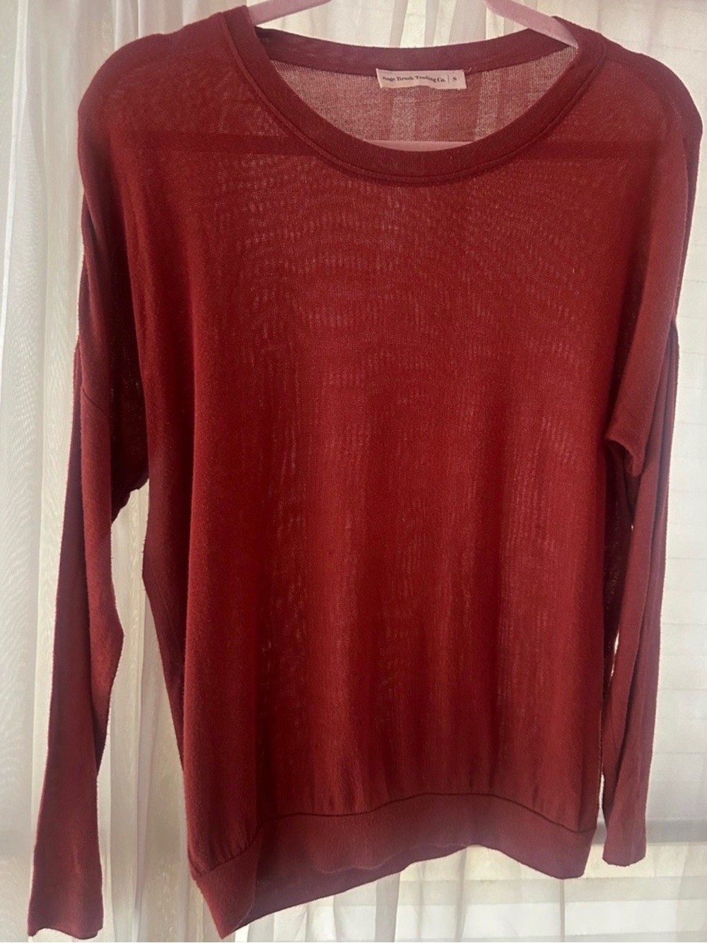 Long sleeved rust colored light sweater